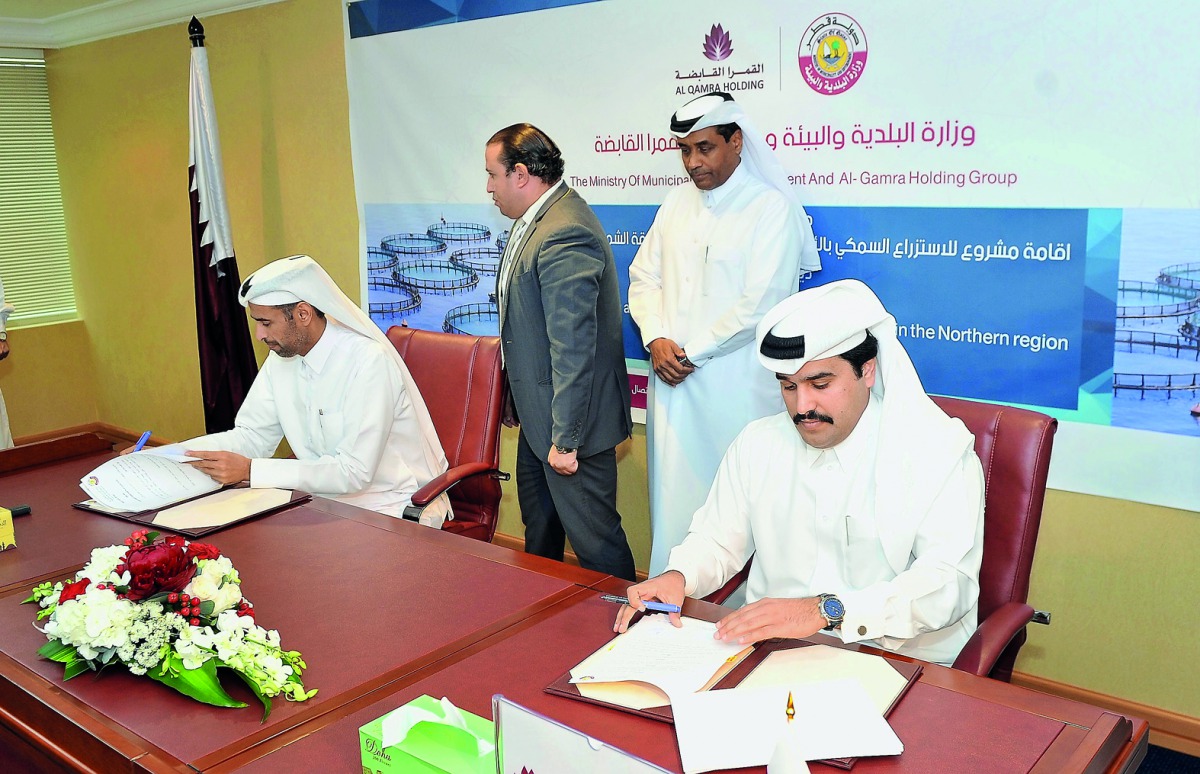 Sheikh Dr. Faleh bin Nasser Al Thani (left), Assistant Under-Secretary for Agriculture and Fisheries Affairs at the Ministry of Municipalities and Environment and Hamad Saleh Al Qamra, Chairman of AL Qamra Holding Group, during the signing of renting agre