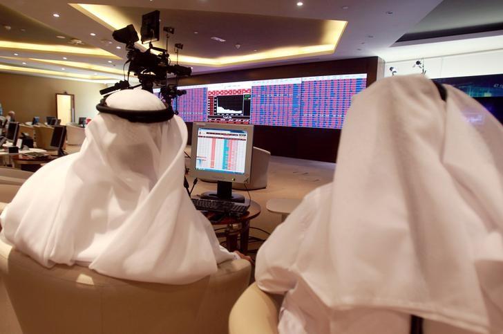 Traders monitor screens displaying stock information at Qatar Stock Exchange in Doha, Qata. REUTERS/ File photo
