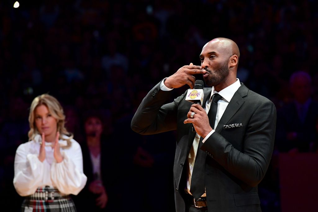 LOS ANGELES, CA - DECEMBER 18: Kobe Bryant addresses the crowd at halftime as both his #8 and #24 Los Angeles Lakers jerseys are retired at Staples Center on December 18, 2017 in Los Angeles, California. Harry How/AFP