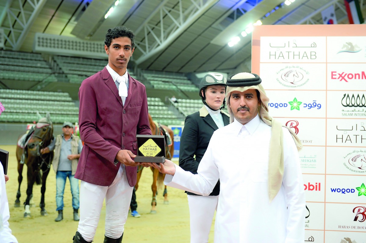 Qatari rider Ghanim Nasser Al Qadi, winner of the Small Tour - Table A, One round against the clock with Jump off Art. 238.2.2, 100/115cm event, receiving his trophy during the presentation ceremony at Al Shaqab Arena yesterday.