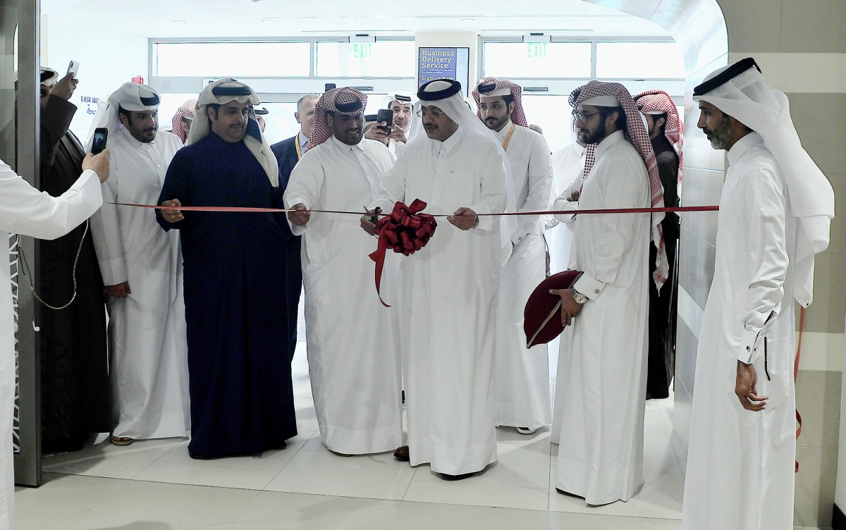 Faleh Al Naemi, Chairman and Managing Director of Qatar Post, and other officials cutting a ribbon to mark the inauguration of the Q-Post’s re-branded Al Rayyan Branch yesterday. Pic: Baher Amin/The Peninsula