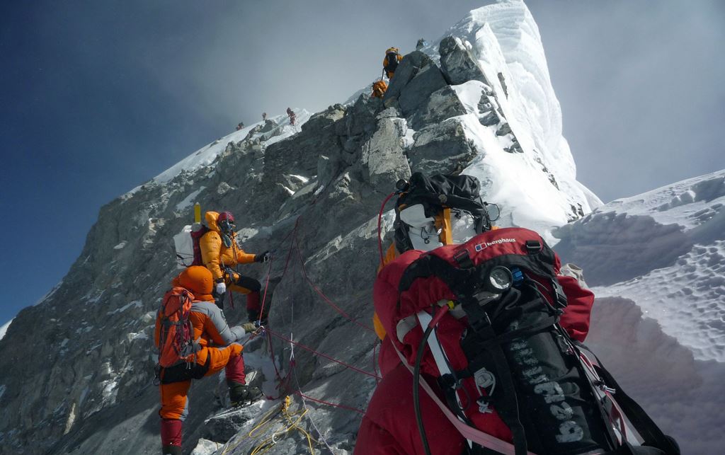 (FILES) In this file photograph taken on May 19, 2009, mountaineers walk past the Hillary Step while pushing for the summit of Mount everest as they climb the south face of the mountain from Nepal. AFP / STR 