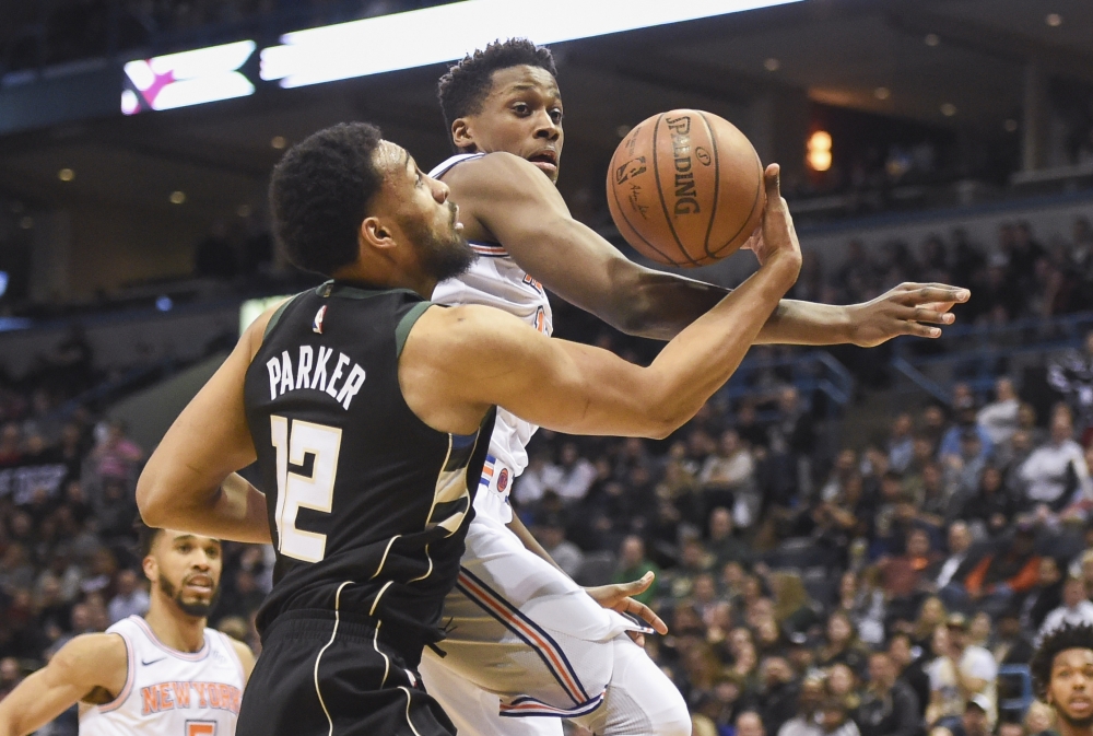 Milwaukee Bucks forward Jabari Parker (12) takes a shot while New York Knicks guard Frank Ntilikina (11) defends in the first quarter at the BMO Harris Bradley Center.  Benny Sieu