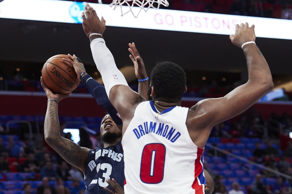 Memphis Grizzlies guard Ben McLemore (23) shoots on Detroit Pistons center Andre Drummond (0) in the first half at Little Caesars Arena. Rick Osentoski