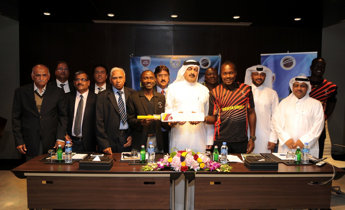 Yousef Jeham Al Kuwari, President of Qatar Cricket Association QCA (centre) presenting a memento to Ugandan team manager Jackson in the presence of QCA and Uganda cricket officials during a press conference held in Doha yesterday. Picture: Abdul Basit/The