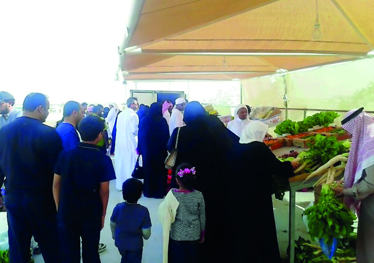 People buying vegetables at a winter market.