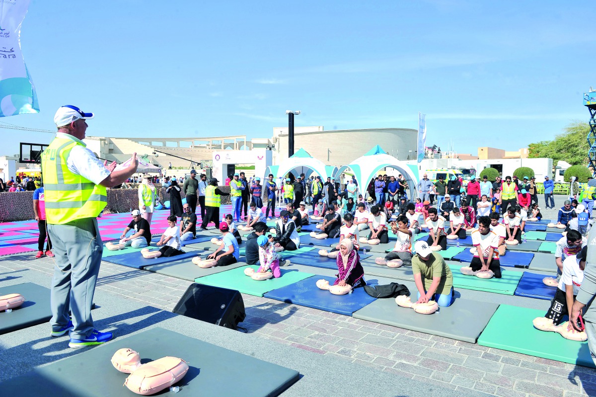 The visitors learn to perform Cardiopulmonary Resuscitation (CPR), a life-saving technique, as part of HMC’s National Sport Day activity at Katara.  Pic:  Baher Amin / The Peninsula 