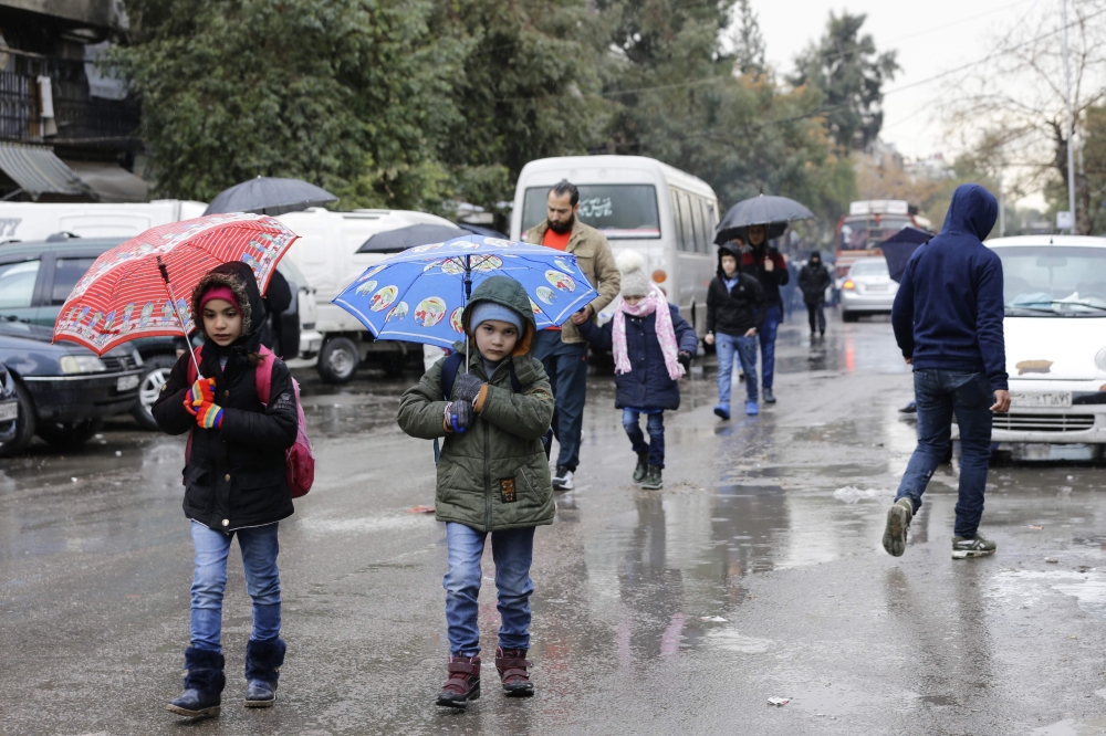 Syrian students head to school on February 18, 2018, following days of calm in Damascus's Old City that has been bombarded by rebels entrenched on the capital's outskirts.  AFP / LOUAI BESHARA
