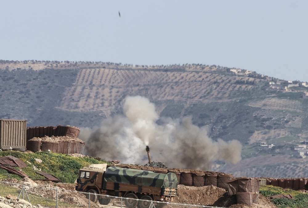 A photo taken from Turkey's Hatay province, on February 18, 2018 shows Turkish Army Forces' artillery units continue to hit PYD/PKK terror group targets across Hatay's Reyhanli, Hassa and Kirikhan districts within the 'Operation Olive Branch' launched in 