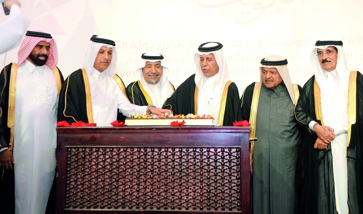 H E Ahmed bin Abdullah bin Zaid Al Mahmoud (third right), Speaker of the Advisory Council, and H E Ali Shareef Al Emadi (second left), Minister of Finance, cutting a cake with Kuwait Ambassador to Qatar, Hafeez Mohamed Salem Al Ajmi (third left), Minister