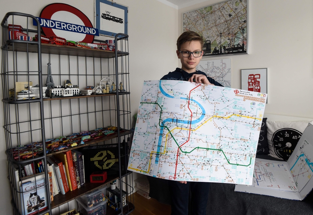 Matej Hosek, a Czech schoolboy with Asperger syndrom, shows a map that he designed, on January 29, 2018, in his bedroom in the village of Cernosice, Czech Republic. AFP / Michal Cizek 