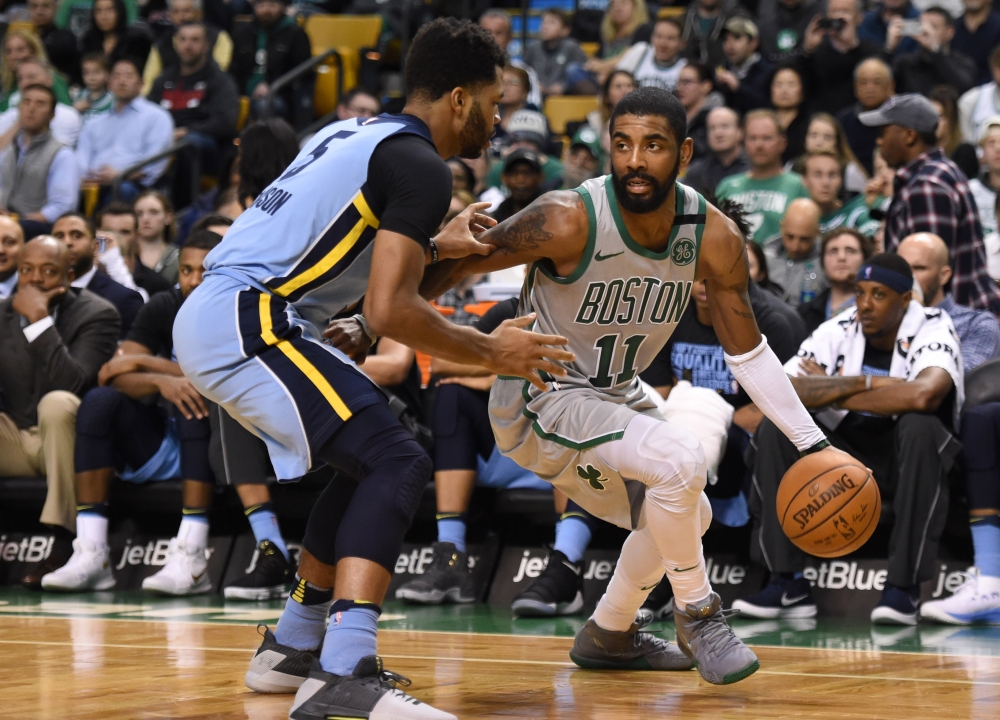 Boston Celtics guard Kyrie Irving (11) controls the ball against Memphis Grizzlies guard Andrew Harrison (5) during the second half at TD Garden.  Bob DeChiara 
