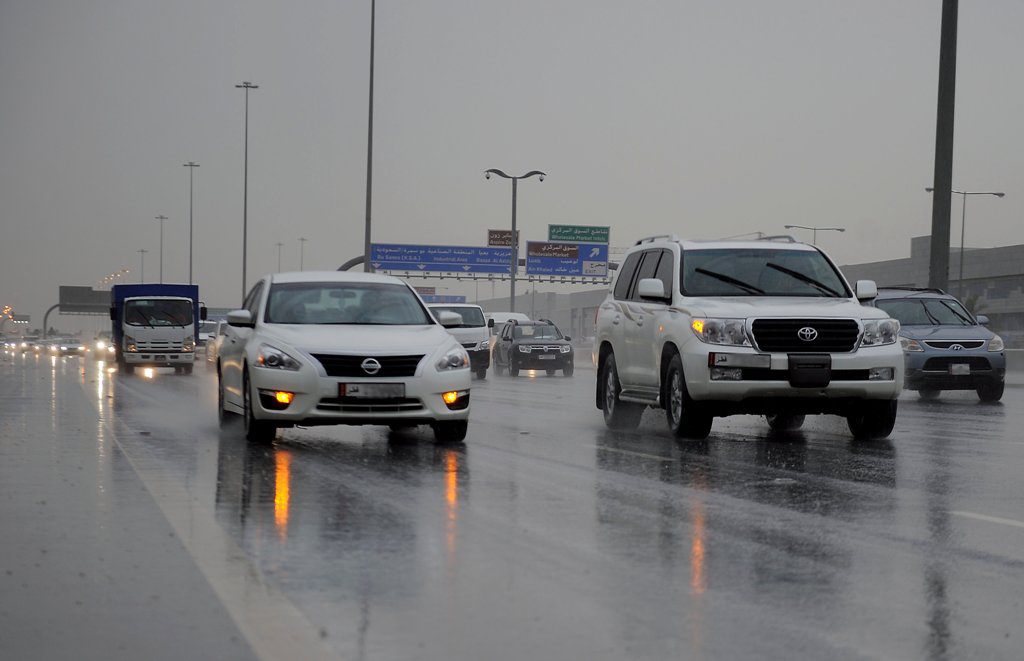 (File Photo) Cars moving in heavy rain on Salwa road. March 16, 2016. Abdul Basit © The Peninsula