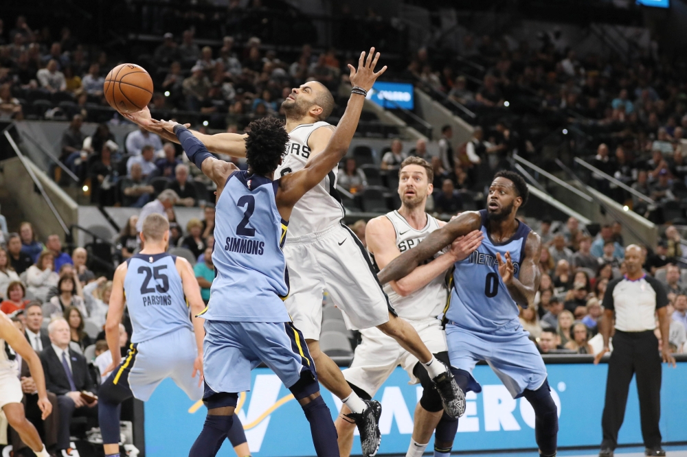 San Antonio Spurs point guard Tony Parker (9) is fouled while shooting by Memphis Grizzlies point guard Kobi Simmons (2) during the first half at AT&T Center.  Soobum Im