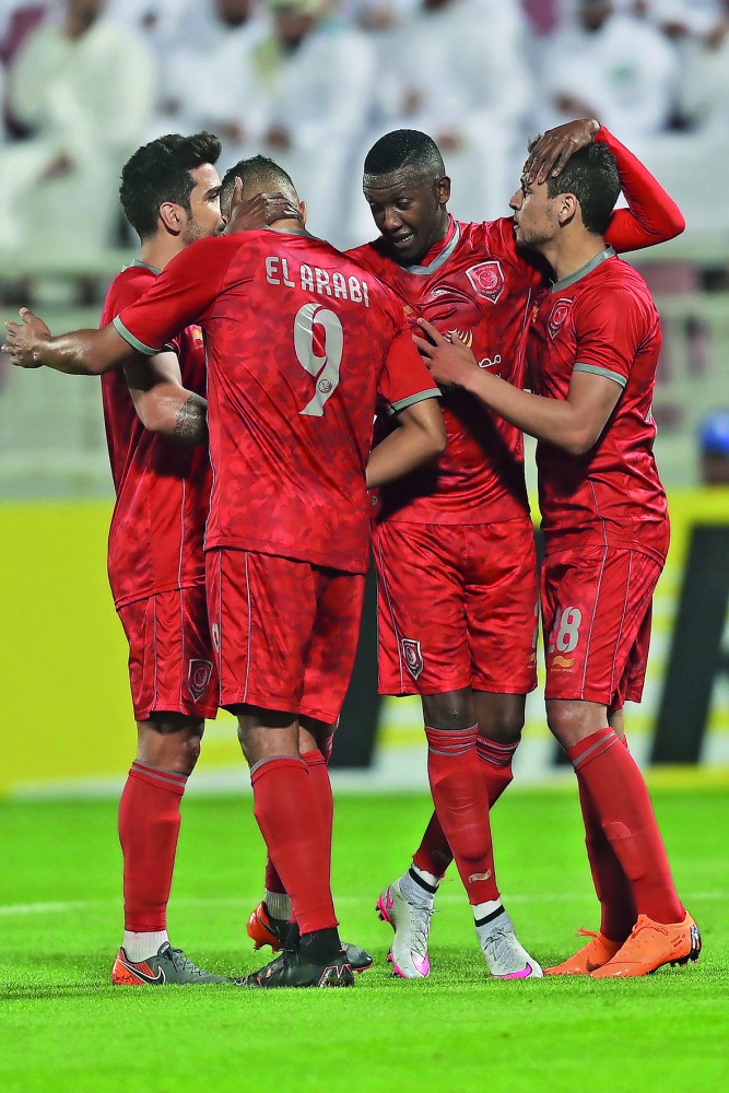 Al Duhail’s Youssef El Arabi celebrates with team-mates during their AFC Champions League match against Lokomotiv of Uzbekistan Tuesday in Doha. 