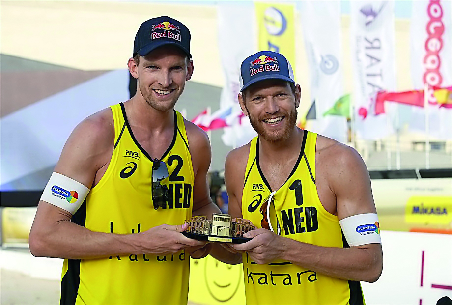 Robert Meeuwsen (left) and Alexander Brouwer celebrate their first World Tour gold of 2018, at Katara Beach yesterday. 