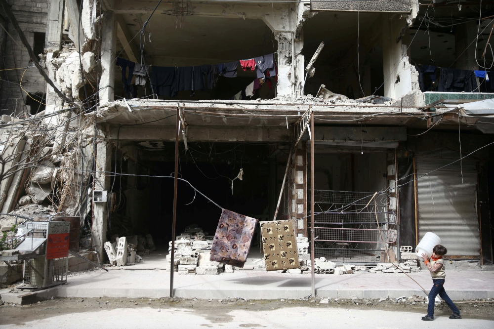 A boy is seen in the besieged town of Douma, Eastern Ghouta, in Damascus, Syria March 8, 2018. REUTERS/Bassam Khabieh/File Photo
