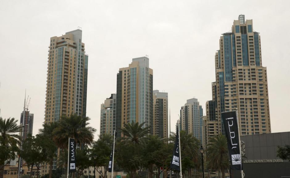 Flags for property company EMAAR are seen in front of buildings in Dubai, UAE March 7, 2016. REUTERS/Ahmed Jadallah
