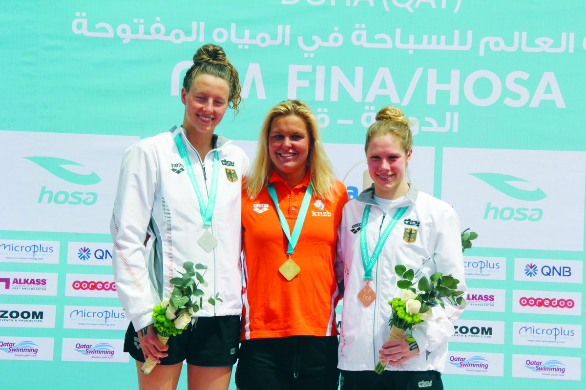 Sharon Van Rouwendaal, Leonie Beck and Finnia Wunram pose on the podium during the  FINA/HOSA Marathon Swim World Series at the Doha Corniche yesterday.