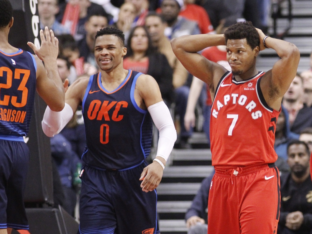 Toronto, Ontario, CAN; Oklahoma City Thunder guard Russell Westbrook (0) and Toronto Raptors guard Kyle Lowry (7) react after a play at the Air Canada Centre. Oklahoma City defeated Toronto. John E. Sokolowski
