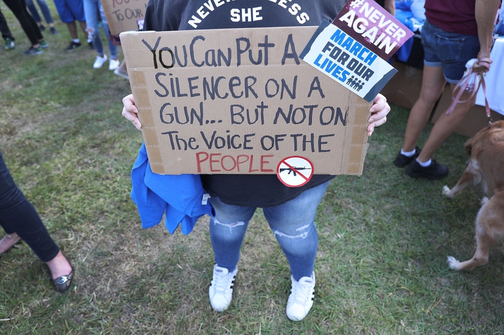 Sophie Phillips holds a sign as she attends a rally for those heading to the March for Our Lives event in Washington D.C. on March 20, 2018 in Parkland, Florida. The rally was held in the name of the 17 students and school staff killed on Valentines Day a