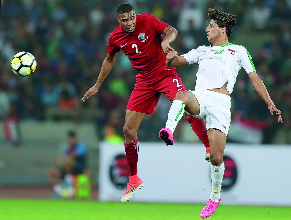 Iraq’s Mohanad Al Kadhim (left) vies for the ball against Qatar’s Pedro Miguel during the Tri-nation Friendship Tournament match at the Basra Sports City Stadium in Basra, Iraq yesterday. Qatar won 3-2.