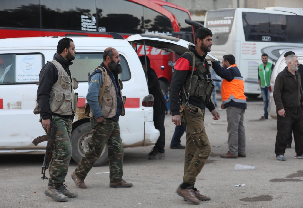 Syrian civilians and fighters arrive in Qalaat al-Madiq, some 45 kilometres northwest of the central city of Hama, on April 2, 2018 after being evacuated from the Eastern Ghouta town of Douma.   AFP / OMAR HAJ KADOUR
