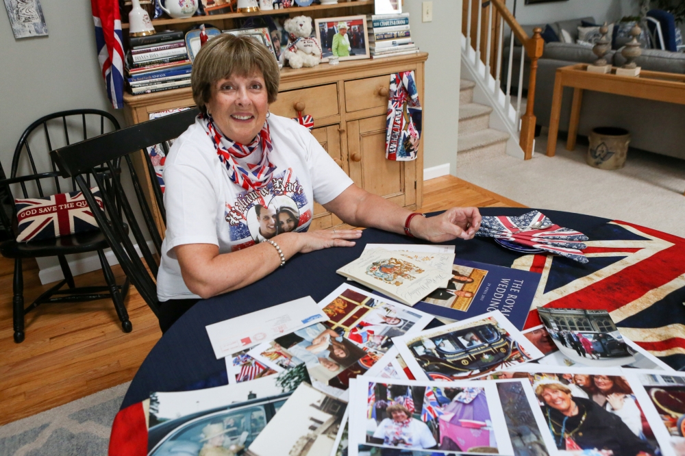 Royal superfan Donna Werner poses with some of the photos and memorabilia she has collected traveling to England for the weddings of Prince Andrew, Prince William and Queen Elizabeth's 90th birthday celebration, at her home in New Fairfield, Connecticut, 