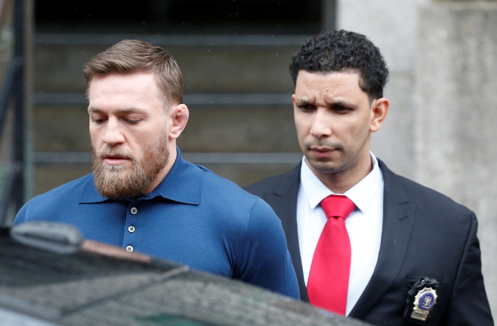 Mixed Martial Arts fighter Conor McGregor is escorted by New York City Police (NYPD) detectives from the 78th police precinct after charges were laid against him in the Brooklyn borough of New York City, U.S., April 6, 2018. Reuters/Brendan McDermid