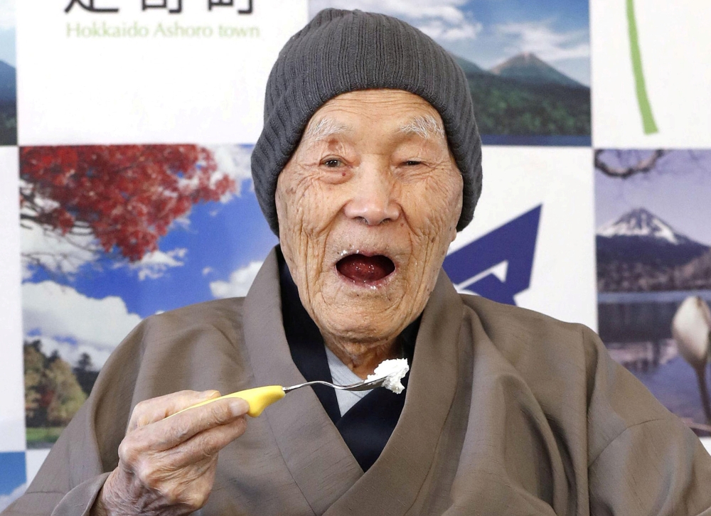 Japanese Masazo Nonaka, who was born 112 years and 259 days ago, eats his favorite cake as he receives a Guinness World Records certificate naming him the world's oldest man during a ceremony in Ashoro, on Japan's northern island of Hokkaido, in this phot