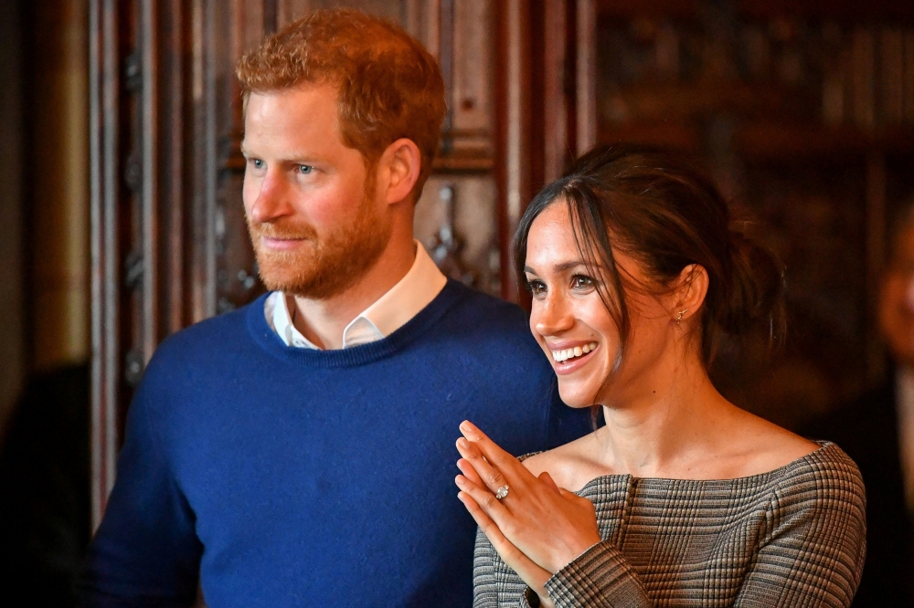 Britain's Prince Harry and his fiancee Meghan Markle watch a performance by a Welsh choir in the banqueting hall during a visit to Cardiff Castle in Cardiff, Britain, January 18, 2018. Reuters/Ben Birchall