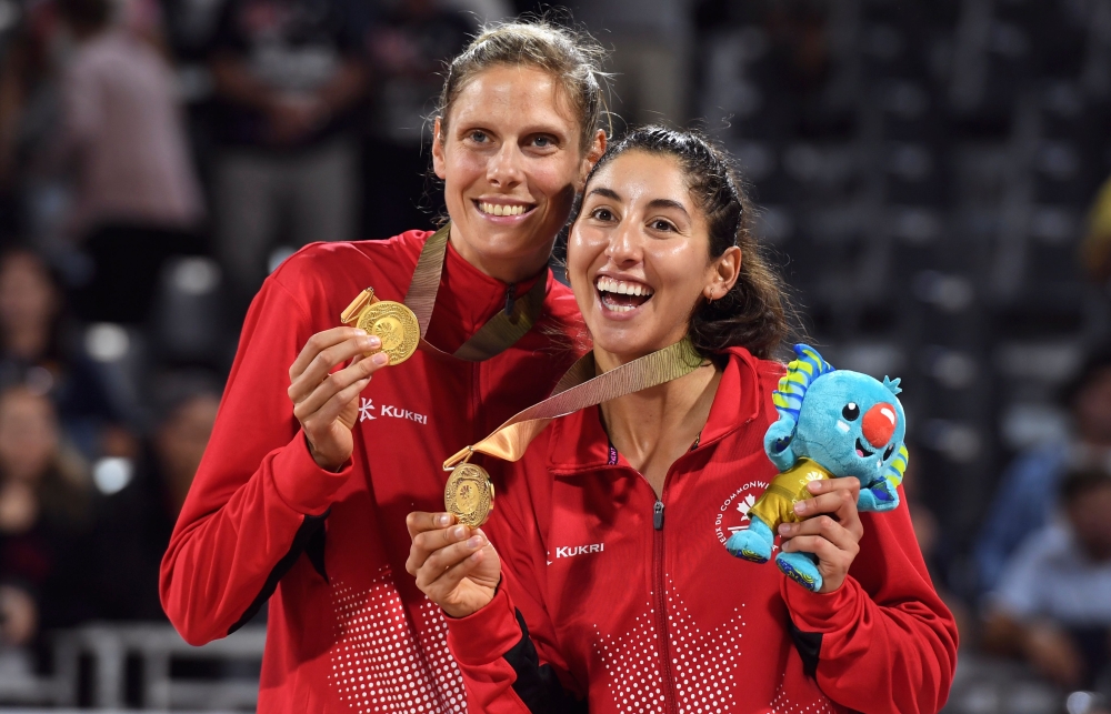 Canada's Sarah Pavan (L) and Melissa Humana-Paredes (R) kiss their gold medals after winning the women's beach volleyball final against Australia at the 2018 Gold Coast Commonwealth Games in Gold Coast on April 12, 2018. AFP / William West