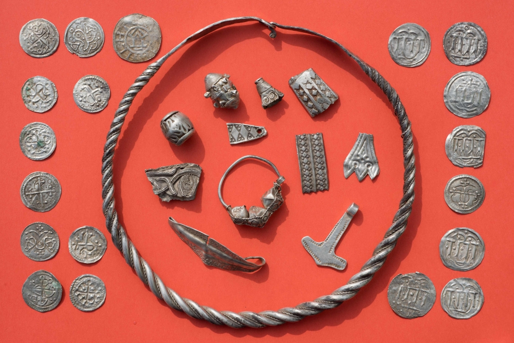 Parts of the silver treasure are pictured on a table in Schaprode, northern Germany on April 13, 2018. A 13-year-old boy and a hobby archaeologist have unearthed a 