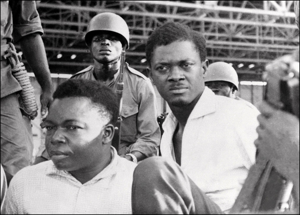 This November 01, 1960 photo shows soldiers guarding prime minister of then Congo-Kinshasa, Patrice Lumumba (R), and vice-president of the Senate, Joseph Okito, upon their arrest in Leopoldville (now Kinshasa).  AFP