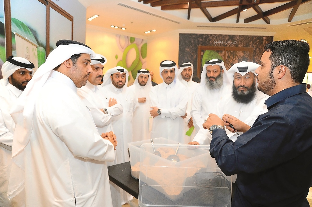 Ahmed Mohammed Al Sada (fifth right), Assistant Under-Secretary for Environment Affairs, with other officials from the Ministry, is being explained about recycling device (Tadweer) at the event in Al Khor Park yesterday.