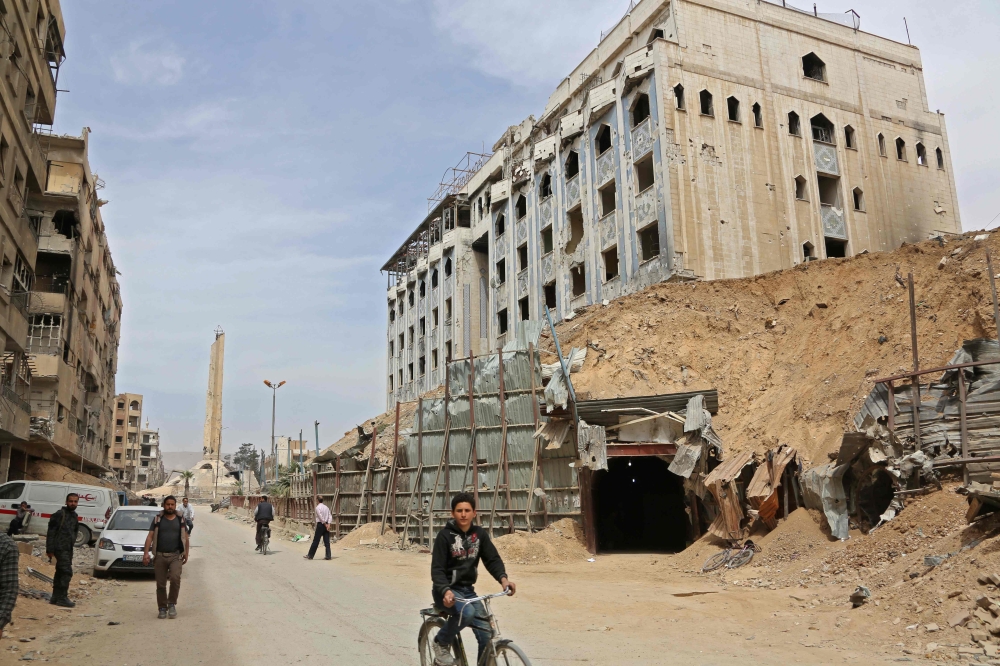 A picture taken on April 17, 2018 in the Syrian town of Douma shows an entrance to a labyrinth of tunnels under Eastern Ghouta which was use by rebel fighters, after the Syrian army declared that all anti-regime forces have left the area, following a blis