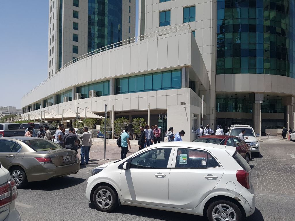 Employees outside their offices in West Bay. Pic: Abdul Basit / The Peninsula 