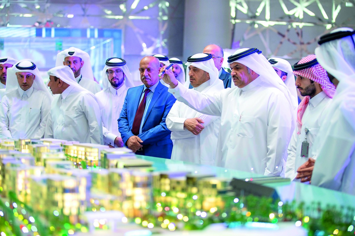 Prime Minister and Interior Minister H E Sheikh Abdullah bin Nasser bin Khalifa Al Thani, Minister of Transport and Communications H E Jassim bin Saif Al Sulaiti, President & CEO of UDC, Ibrahim Jassim Al Othman, and other dignitaries looking at model of 