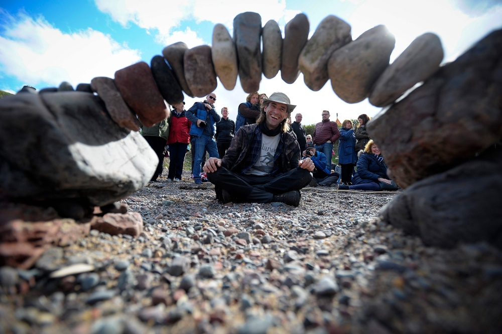 Overall winner, Pedro Duran from Spain, competes in the European Stone Stacking Championships 2018 in Dunbar, Scotland, on April 22, 2018.  AFP / Andy Buchanan