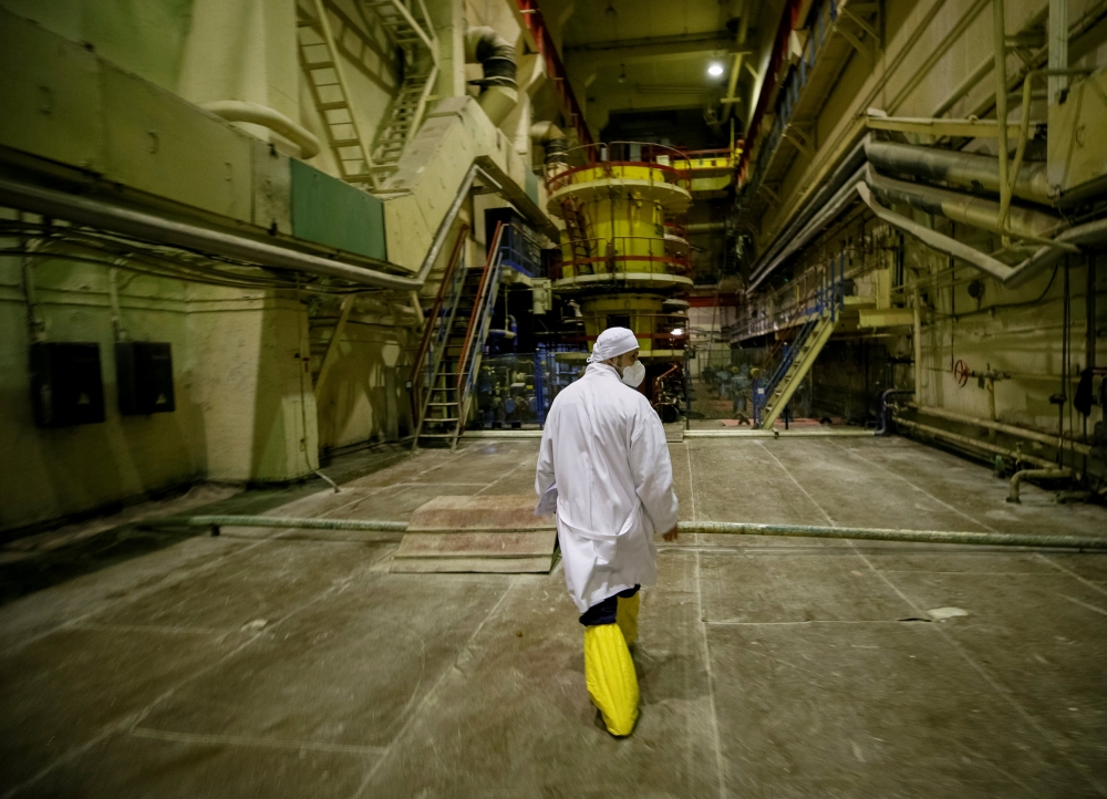 An employee walks through a pump room of the stopped third reactor at the Chernobyl nuclear power plant in Chernobyl, Ukraine April 20, 2018. Reuters/Gleb Garanich