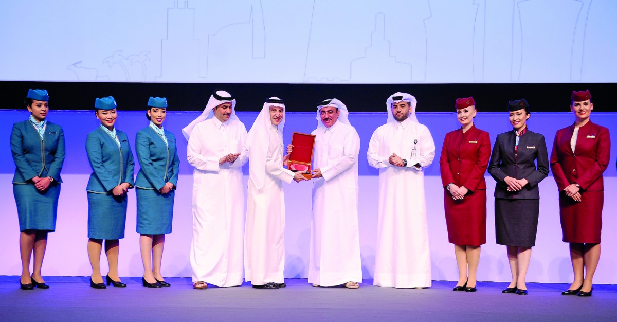 Akbar Al Baker (second left), Group Chief Executive of Qatar Airways, handing over a memento to H E Jassim bin Saif Al Sulaiti, Minister of Transport and Communications, during the IATA conference at Sheraton Doha yesterday. Pic:Abdul Basit / The Peninsul