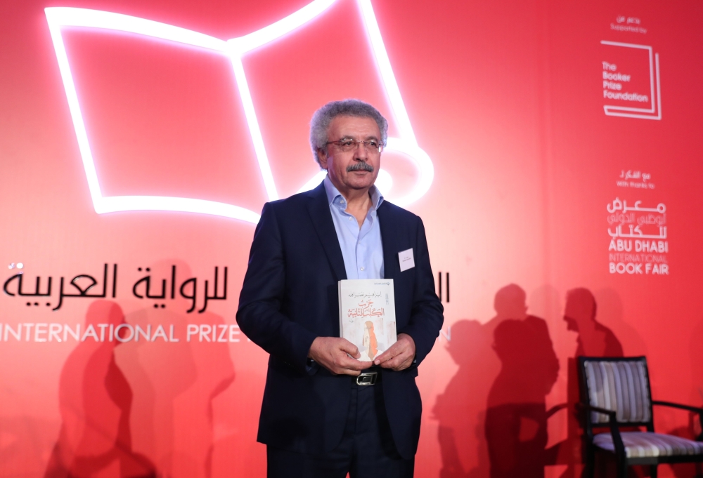 Palestinian writer Ibrahim Nasrallah poses for a photo after winning the 2018 International Prize for Arabic Fiction for his book titled 