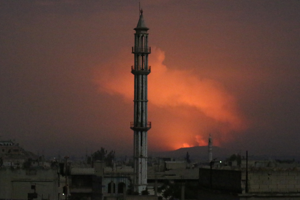 Smoke rises after military points of the 47th regiment of the Assad regime were hit on April 30, 2018 in Hama, Syria. Mahmoud Taha - Anadolu 
