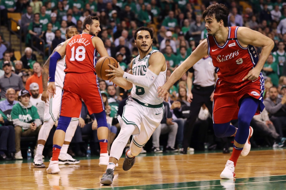 Shane Larkin #8 of the Boston Celtics drives to the basket past Dario Saric #9 of the Philadelphia 76ers during the second half of Game One in Round Two of the 2018 NBA Playoffs at TD Garden on April 30, 2018 in Boston, Massachusetts.   Maddie Meyer/ AFP 