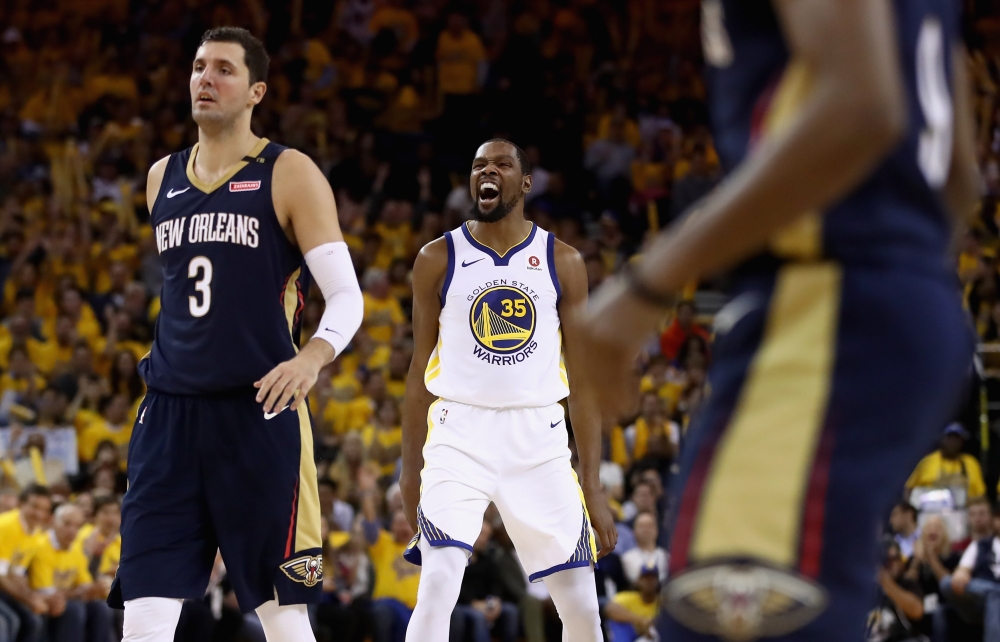 Kevin Durant #35 of the Golden State Warriors reacts after making a basket against the New Orleans Pelicans during Game Five of the Western Conference Semifinals of the 2018 NBA Playoffs at ORACLE Arena on May 8, 2018 in Oakland, California.Ezra Shaw/AFP