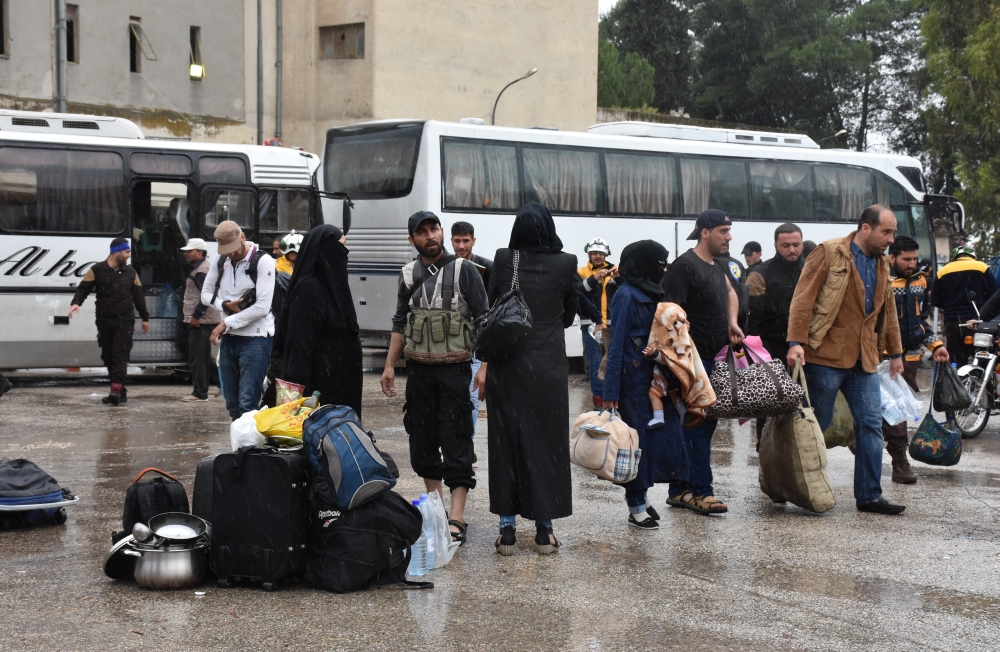 The fourth convoy carrying civilians depart from the Free Syrian Army (FSA) controlled area of Yarmouk Camp in southern Damascus under the Yarmouk camp evacuation agreement, as part of the compulsory evacuation as agreed on April 29, in Damascus, Syria on