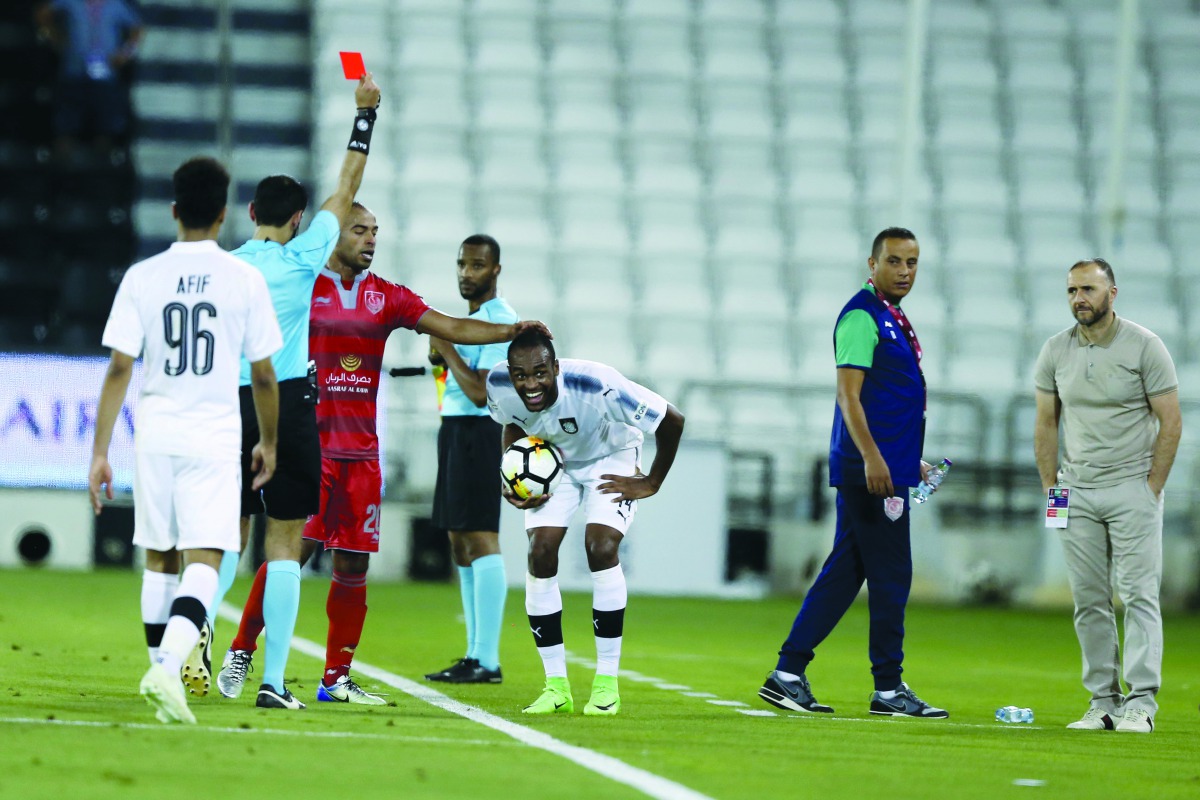 The referee shows the red card to Al Sadd’s Abdelkerem Hassan (right) during the Amir Cup semi-final played at the Al Sadd Stadium yesterday. Picture: Mohamed Farag  