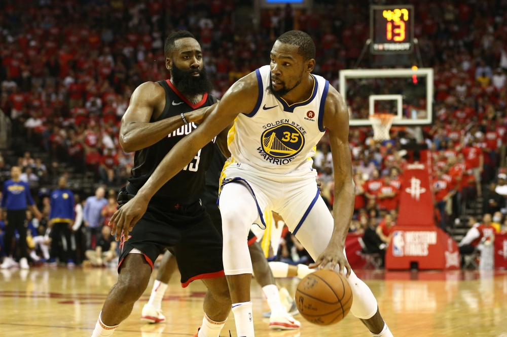 Golden State Warriors forward Kevin Durant (35) dribbles against Houston Rockets guard James Harden (13) during the fourth quarter in game one of the Western conference finals of the 2018 NBA Playoffs at Toyota Center. Troy Taormina-USA TODAY Sports