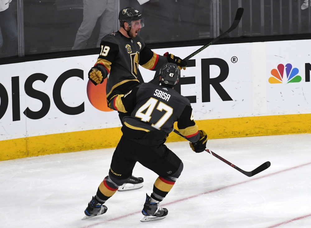 Reilly Smith #19 is congratulated by his teammate Luca Sbisa #47 of the Vegas Golden Knights after scoring a third-period goal against the Winnipeg Jets in Game Four of the Western Conference Finals during the 2018 NHL Stanley Cup Playoffs at T-Mobile Are