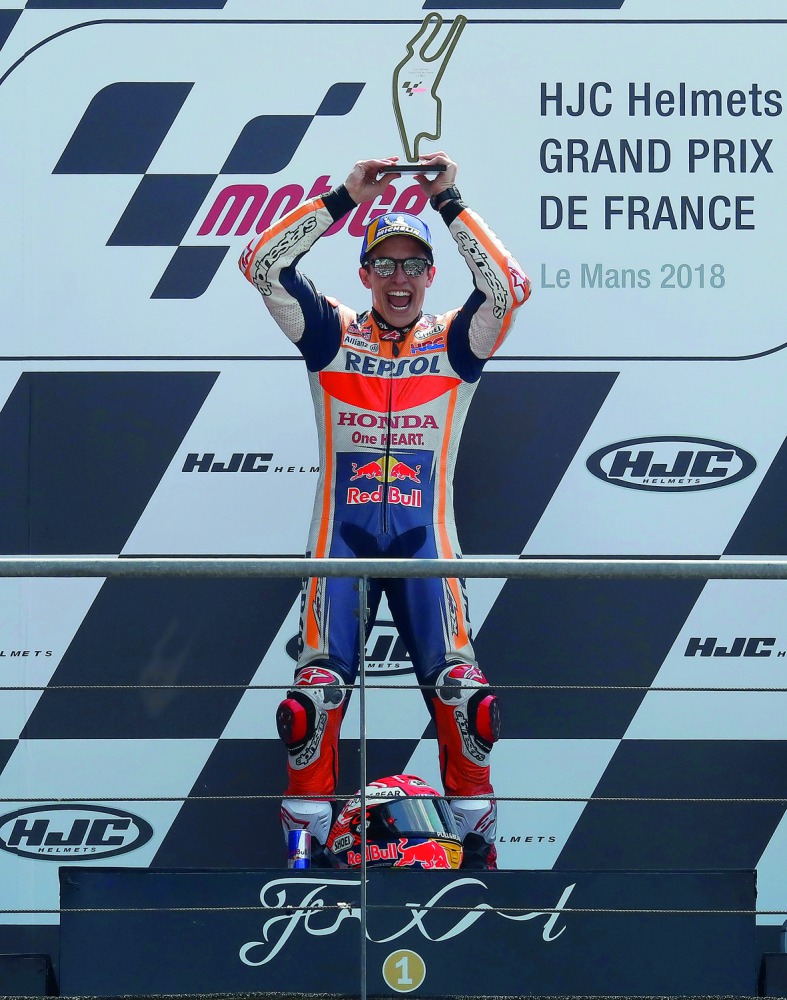 Repsol Honda Team's Marc Marquez celebrates with a trophy after winning the race. Reuters/Gonzalo Fuentes